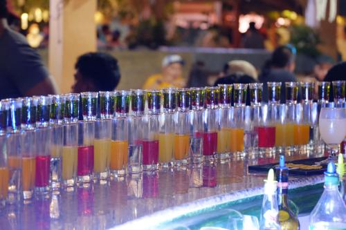 a row of glasses filled with different colored drinks at Nest Resort in Pagudpud