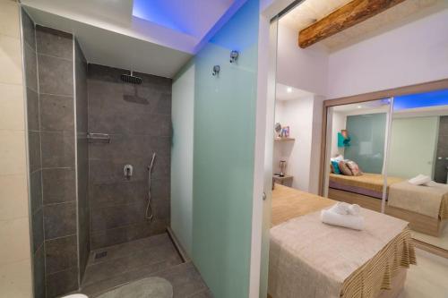 a bathroom with a walk in shower and a walk in shower at JBO- Joette's Bliss Oasis in Valletta