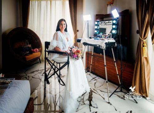 a woman in a wedding dress standing in a room at Nest Resort in Pagudpud