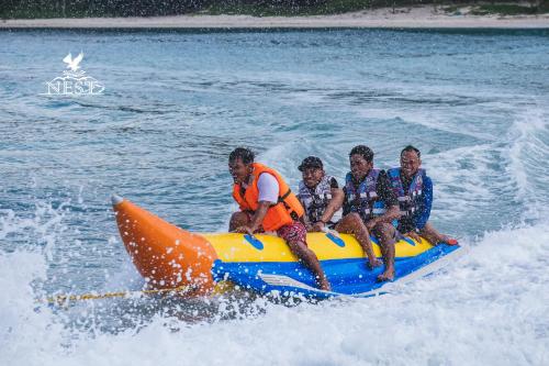 a group of men riding on a raft in the water at Nest Resort in Pagudpud