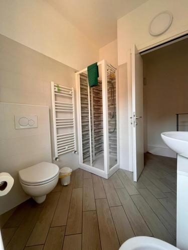 a bathroom with a toilet and a sink at BelSorrisoVarese - Elegance City Residence Private Parking -Reservation Required- in Varese