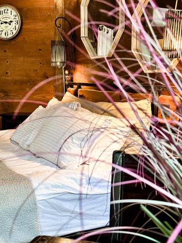 a bedroom with a bed and a clock on the wall at Crimson View in Moshav Ramot