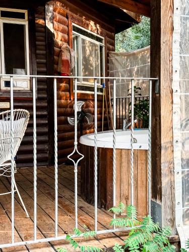 a porch of a log cabin with a table and a chair at Crimson View in Moshav Ramot