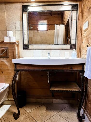 a bathroom with a sink and a mirror at Crimson View in Moshav Ramot
