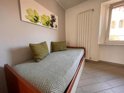 a small bed in a room with a window at BelSorrisoVarese - Elegance City Residence Private Parking -Reservation Required- in Varese