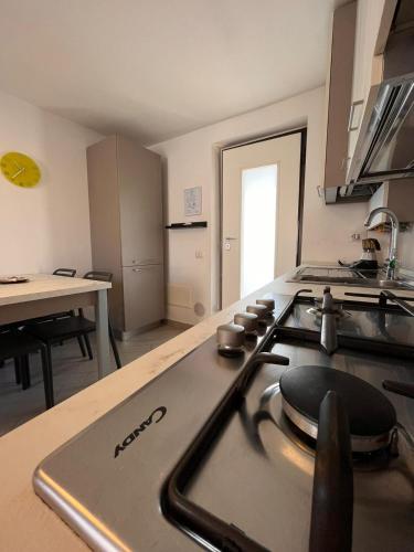 a kitchen with a stove top oven in a kitchen at BelSorrisoVarese - Elegance City Residence Private Parking -Reservation Required- in Varese