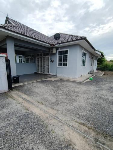 ein weißes Haus mit Kieseinfahrt davor in der Unterkunft Homestay Kemaman Fyna02 di Bukit Kuang in Kampong Kemaman