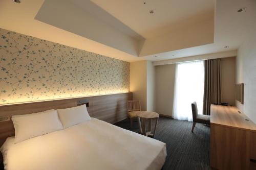 a hotel room with a bed and a desk at TOKYO EAST SIDE HOTEL KAIE in Tokyo