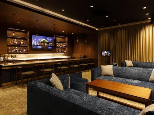 a bar in a restaurant with couches and a bar at TOKYO EAST SIDE HOTEL KAIE in Tokyo