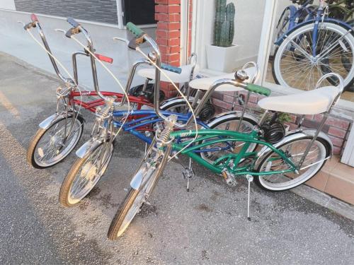 three bikes parked in front of a house at El Sol Town Okinawa in Chatan