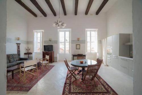 a living room with a table and a dining room at HT3- Heritage Treasure 3 in Valletta