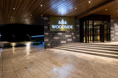 a woodside sign on the side of a building at Aparthotel & SPA Woodside by Anaya in Kopaonik