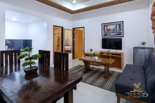 a living room with a table and a couch at Nest Resort in Pagudpud