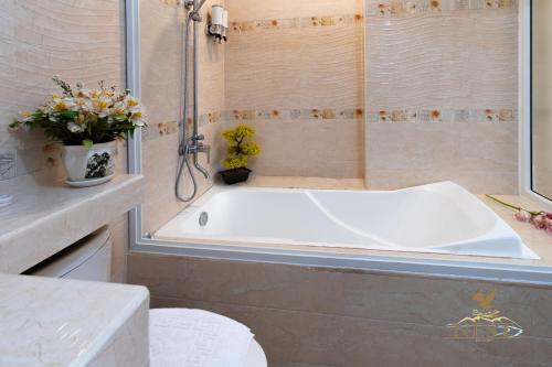 a bathroom with a white tub and a shower at Nest Resort in Pagudpud
