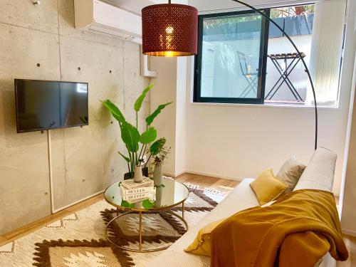 a living room with a couch and a table at Ken's Place四谷 in Tokyo
