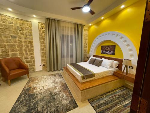 a bedroom with a bed and a yellow wall at palm shadow resort in Tunis