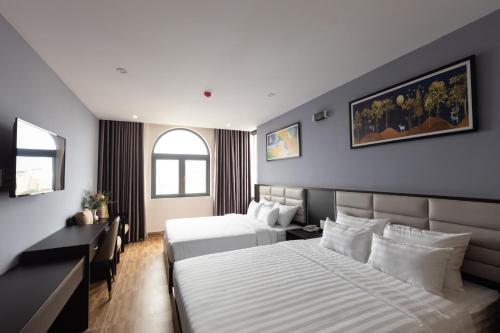Ένα ή περισσότερα κρεβάτια σε δωμάτιο στο NOVELTY VŨNG TÀU HOTEL