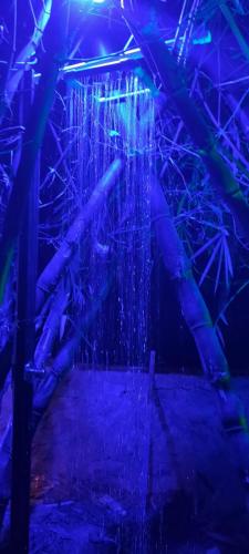 a room with a water fountain with blue lights at Wayanad Three Roots Holiday Home Resort in Sultan Bathery