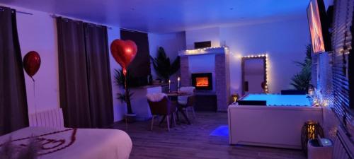 a bedroom with a room with a bed and a room with a tub at Suite de charme avec JACUZZI illimité et jardin privatif in Saint-Prix