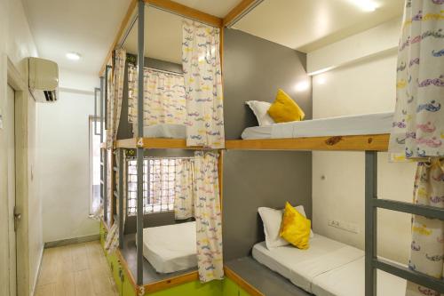 a room with two bunk beds and a window at Moustache Hostel, Jaipur in Jaipur