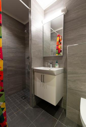 a bathroom with a white sink and a shower at Kongsberg Hostel-Vandrerhjem in Kongsberg