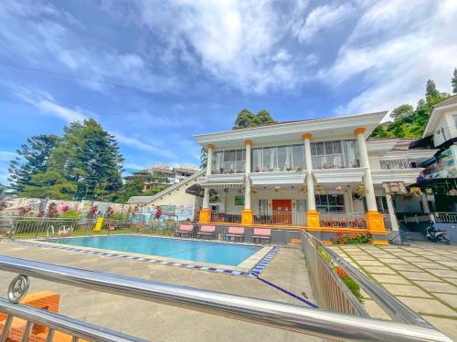 a house with a swimming pool in front of it at Villa London Puncak in Sampal 2