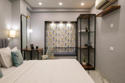 a bedroom with a white bed and a window at Moustache Hostel, Jaipur in Jaipur