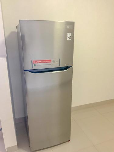 a stainless steel refrigerator with its door open at Villa London Puncak in Sampal 2