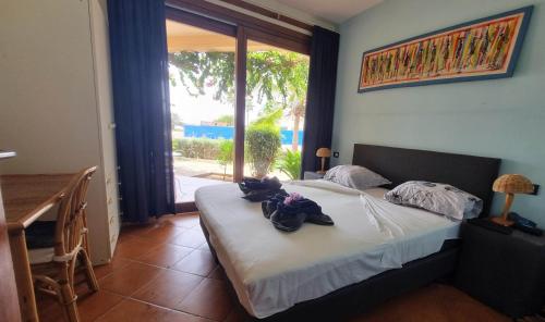 a bedroom with a bed with towels on it at Porto Antigo 2 BeachFront in Santa Maria