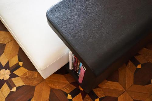 a corner of a bed with a book shelf at Hôtel Particulier Le 28 - Spa & Art Luxury Design by Alain Ducasse in Aix-en-Provence