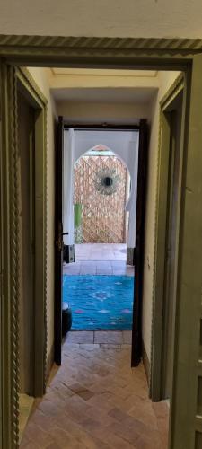 a hallway with a door leading to a brick building at Les Trois Paons in Taroudant