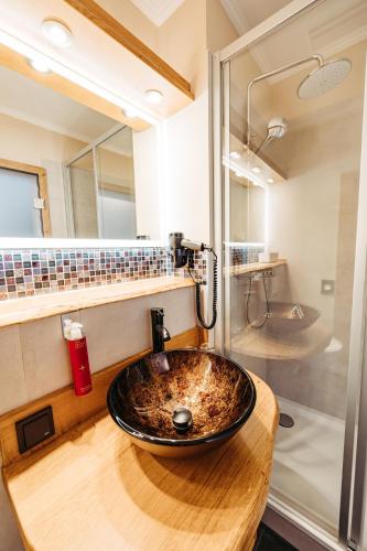 a bathroom with a sink and a shower at Schlosshotel Brilon-Wald in Brilon-Wald