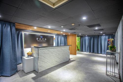 a lobby with blue curtains and a reception counter at 雲沐行旅 Hotel Cloud Arena-Daan in Taipei