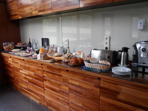 a buffet line with bread and pastries on it at La QuintaEsencia in La Pereda de Llanes