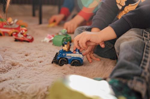 a child playing with a toy truck on the floor at Schlosshotel Brilon-Wald in Brilon-Wald