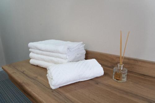 a pile of towels sitting on a wooden table at Jardin in Aktobe