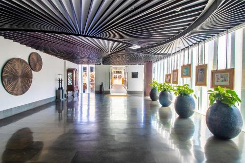 a hallway with vases on the floor and a ceiling at The Sakala Resort Bali All Suites in Nusa Dua
