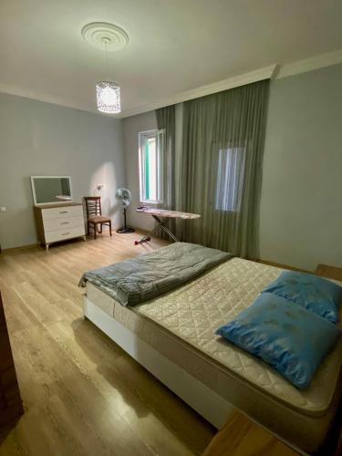 um quarto com uma cama e uma televisão em Family Home em Batumi