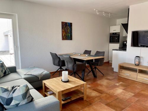 a living room with a couch and a table with chairs at Moderne Ferienwohnung in Bad Waldsee