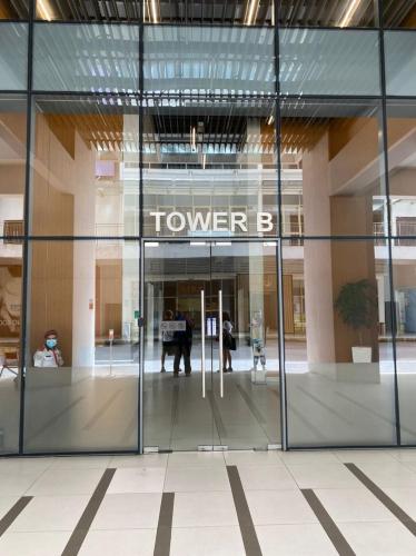 a glass door of a building with a tower b sign at Damen Suite Sunway Subang by DW in Subang Jaya