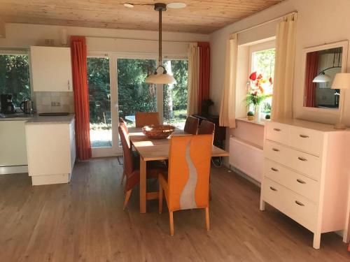 a kitchen and dining room with a table and chairs at Finnish holiday villa with sauna in Norg