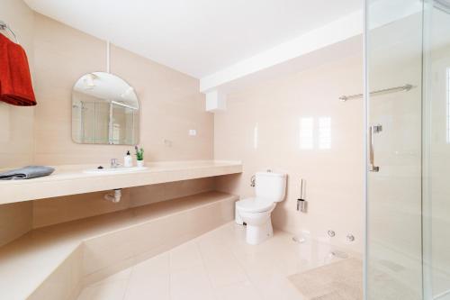 a bathroom with a toilet and a glass shower at Moser Living Premium Apartments in Mogán