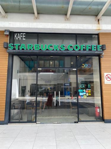 a starbucks coffee store with a sign on the window at Damen Suite Sunway Subang by DW in Subang Jaya