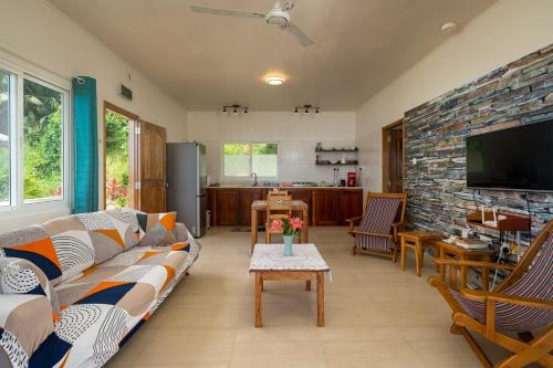a living room with a couch and a tv at TOP VIEW RETREAT SELFCATERING in Anse a La Mouche