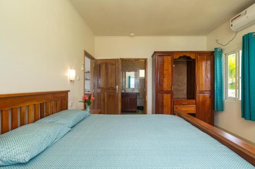 a bedroom with two beds with blue sheets at TOP VIEW RETREAT SELFCATERING in Anse a La Mouche