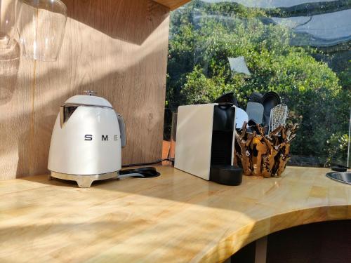 a coffee maker on top of a wooden table at Stargazing Dome - Thunzi Bush Lodge in Beachview