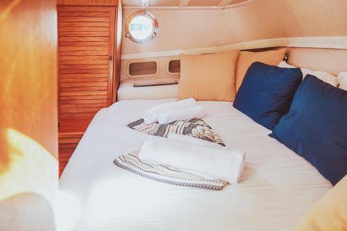 a bed with towels and pillows on it in an rv at The Opportunity to Live on a sailing yacht in Bodrum Marina in Bodrum City