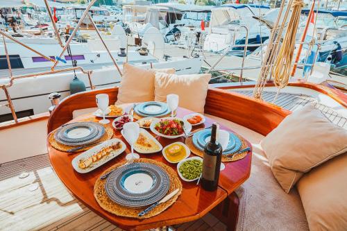 a table with a plate of food on a boat at The Opportunity to Live on a sailing yacht in Bodrum Marina in Bodrum City