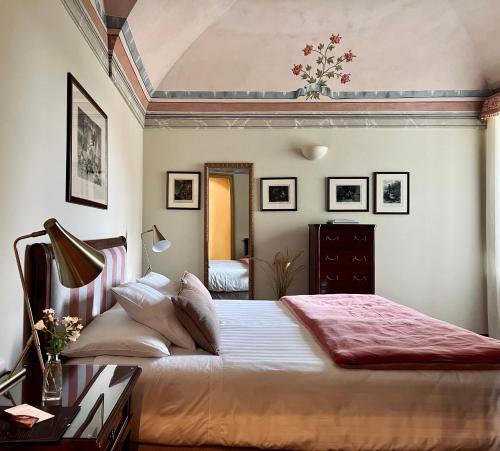 a bedroom with a large bed in a room at Relais San Maurizio in Santo Stefano Belbo
