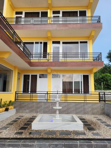 a building with a fountain in front of it at Amoda - Best Hotel in Dharamshala in Dharamshala